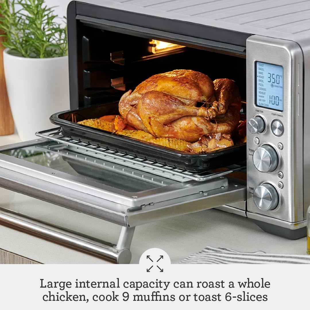 Breville Smart Oven Air Fryer on a kitchen counter, door closed showing controls and window.